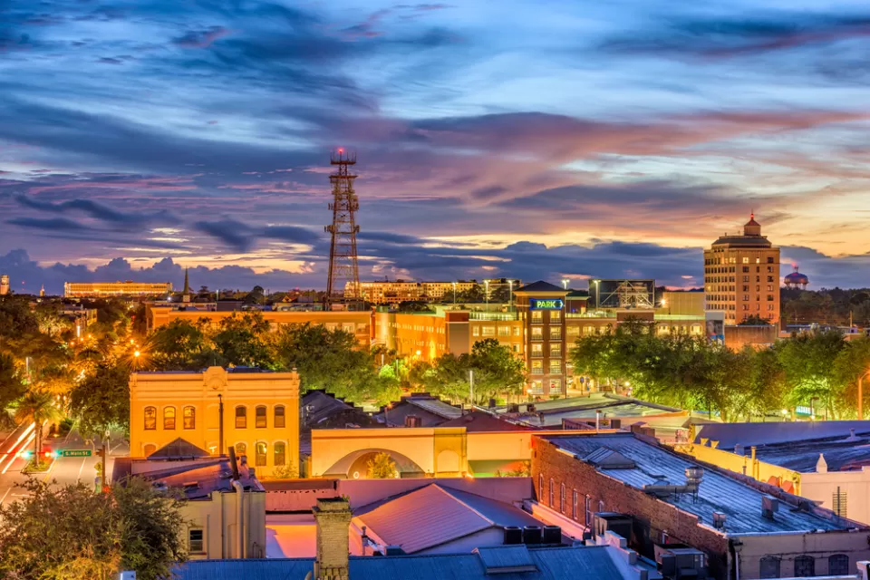 Gainesville, Florida skyline with tall water tower against cloudy sunset sky
